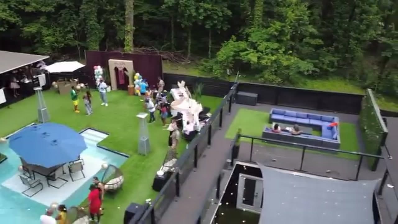 Aerial drone view over a backyard pool party for a 50th birthday
